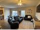 Inviting living room with modern ceiling fan, cozy black leather furniture, and neutral decor at 914 Baden Manor Dr, Indianapolis, IN 46217