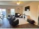 Comfortable living room with a large sectional sofa, flat-screen TV, and access to the outdoor area at 914 Baden Manor Dr, Indianapolis, IN 46217