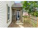 Back porch with a screen door provides a view of the yard with blooming trees in the spring at 9531 Charter Dr, Indianapolis, IN 46250
