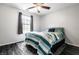 Cozy bedroom features a ceiling fan, area rug, and a comfortable bed with bright blue and white striped covers at 9531 Charter Dr, Indianapolis, IN 46250