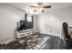 Spacious bedroom with dark wood floors has a large TV and modern entertainment stand with lots of storage at 9531 Charter Dr, Indianapolis, IN 46250
