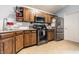 An open kitchen is equipped with stainless steel appliances, tile floor, and breakfast bar at 9531 Charter Dr, Indianapolis, IN 46250