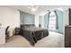 This bright main bedroom is spacious, has a ceiling fan, and a large window at 9531 Charter Dr, Indianapolis, IN 46250