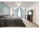 The main bedroom is spacious and bright, featuring a ceiling fan and large window at 9531 Charter Dr, Indianapolis, IN 46250