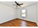 A bright bedroom is accented by a window and ceiling fan at 1018 N 18Th St, Elwood, IN 46036