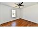 A bright bedroom is accented by a window and ceiling fan at 1018 N 18Th St, Elwood, IN 46036