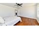 Bright bedroom with wood floors, neutral walls, a ceiling fan, and large windows at 1018 N 18Th St, Elwood, IN 46036