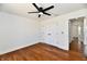 This well-lit bedroom features a ceiling fan, hard wood floors, and a closet at 1018 N 18Th St, Elwood, IN 46036
