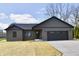 Stylish single-story home with neutral siding, attached garage, and a concrete driveway on a partly cloudy day at 1018 N 18Th St, Elwood, IN 46036