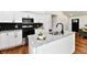 Modern kitchen with white cabinets, granite countertops, stainless steel appliances, and black subway tile backsplash at 1018 N 18Th St, Elwood, IN 46036
