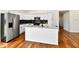 Bright kitchen with stainless steel appliances, white cabinetry, an island with seating, and hardwood floors at 1018 N 18Th St, Elwood, IN 46036
