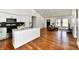 Stylish living area seamlessly blending with the kitchen, featuring an island and hardwood floors at 1018 N 18Th St, Elwood, IN 46036
