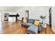 Open-concept living room and kitchen area with hardwood floors and a comfortable sofa with bright pillows at 1018 N 18Th St, Elwood, IN 46036