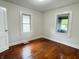 This bedroom has hardwood floors and two windows for natural light at 1032 Groff Ave, Indianapolis, IN 46222
