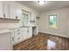Bright kitchen featuring modern white cabinets, sleek black hardware, subway tile backsplash, and new countertops at 1032 Groff Ave, Indianapolis, IN 46222
