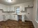 Bright kitchen featuring modern white cabinets, sleek black hardware, subway tile backsplash, and new countertops at 1032 Groff Ave, Indianapolis, IN 46222