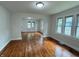 Bright living room featuring gleaming hardwood floors, modern lighting, and multiple windows at 1032 Groff Ave, Indianapolis, IN 46222