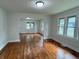 Bright living room featuring gleaming hardwood floors, modern lighting, and multiple windows at 1032 Groff Ave, Indianapolis, IN 46222