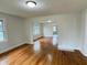 Bright living room featuring gleaming hardwood floors, modern lighting, and multiple windows at 1032 Groff Ave, Indianapolis, IN 46222