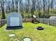 Spacious backyard with a shed, play set, fire pit, and well-maintained lawn at 1117 Hendricks Ave, Shelbyville, IN 46176