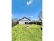 Spacious backyard featuring a fire pit and a well-manicured lawn surrounded by a wooden fence at 1117 Hendricks Ave, Shelbyville, IN 46176