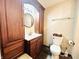 Bathroom featuring dark wood cabinets, a modern toilet and sink at 1117 Hendricks Ave, Shelbyville, IN 46176