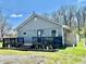 Exterior view of home showing gray siding, a black deck, and green lawn at 1117 Hendricks Ave, Shelbyville, IN 46176