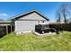 Exterior view of home showcasing back deck, green lawn, and wooden fence at 1117 Hendricks Ave, Shelbyville, IN 46176