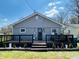 Charming home featuring a lovely front deck, gray siding, and well-maintained landscaping at 1117 Hendricks Ave, Shelbyville, IN 46176