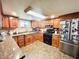 Bright kitchen with wooden cabinets, modern appliances, and stone tile flooring at 1117 Hendricks Ave, Shelbyville, IN 46176