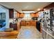 Kitchen featuring dark wooden cabinets, stainless steel appliances, and stone flooring at 1117 Hendricks Ave, Shelbyville, IN 46176