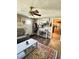 Cozy living room featuring wood floors, modern fan, and a view to the kitchen at 1117 Hendricks Ave, Shelbyville, IN 46176