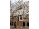 A large wooden deck provides access to the yard, complemented by flowering trees and mature landscaping at 11203 Westminster Way, Carmel, IN 46033