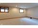 Unfinished basement offers a blank canvas, with neutral carpet, natural light and ample potential at 11203 Westminster Way, Carmel, IN 46033