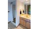 Bathroom featuring shower stall, vanity with mirror, and patterned wallpaper at 11203 Westminster Way, Carmel, IN 46033