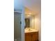 Bathroom with walk-in shower and single sink vanity with a large mirror at 11203 Westminster Way, Carmel, IN 46033
