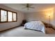 Comfortable bedroom with a ceiling fan, large window, and neutral color scheme at 11203 Westminster Way, Carmel, IN 46033