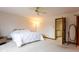 Cozy bedroom features a queen bed, ceiling fan, and an adjacent sitting area at 11203 Westminster Way, Carmel, IN 46033