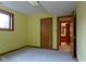 Bedroom featuring a window, carpeted flooring, door, and closet at 11203 Westminster Way, Carmel, IN 46033