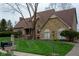 Charming stone home featuring a manicured lawn, a welcoming entryway, and a new roof at 11203 Westminster Way, Carmel, IN 46033