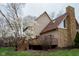 Back of a beautiful home featuring a stone chimney and a large deck perfect for outdoor entertaining at 11203 Westminster Way, Carmel, IN 46033