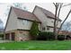 Charming home showcasing a mix of stone and siding exterior, mature trees, and a well-maintained lawn at 11203 Westminster Way, Carmel, IN 46033