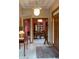 Spacious foyer featuring tiled flooring, a decorative light fixture, and a view into the dining room at 11203 Westminster Way, Carmel, IN 46033