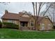 Charming stone home with a well-maintained lawn and inviting entryway at 11203 Westminster Way, Carmel, IN 46033