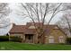 Inviting stone home with a manicured lawn, appealing roof, and a cozy, classic design at 11203 Westminster Way, Carmel, IN 46033