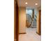 Bright hallway with staircase, featuring neutral colors and carpet flooring at 11203 Westminster Way, Carmel, IN 46033