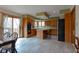 Open kitchen features an island with breakfast bar, stainless appliances and sliding door to deck at 11203 Westminster Way, Carmel, IN 46033