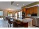 Bright kitchen view showcasing the island, cooktop, pendant lighting and stainless appliances at 11203 Westminster Way, Carmel, IN 46033