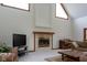 Spacious living room featuring a fireplace, TV, grand piano, and ample seating at 11203 Westminster Way, Carmel, IN 46033