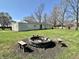 Large backyard features a fire pit area with benches and lots of green space for Gathering fun at 1210 W Grant St, Thorntown, IN 46071